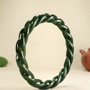 “Elegant Natural Hetian Jade Green Bangle – Hand-Carved Twist Design, Ice-Type Texture, Symbol of Grace and Serenity